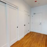 Apartment entryway with sliding doors near entry door