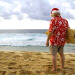 Santa Claus surfing on the California shoreline
