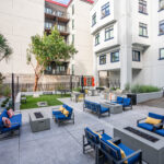 Outdoor courtyard with firepits, comfortable seating, games, grills, and bike storage
